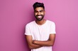 © Gelpi - Handsome Indian guy laughing on pink background. Generative AI