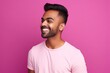 © Gelpi - Handsome Indian guy laughing on pink background. Generative AI