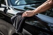 Leinwanddruck Bild - A man cleaning car with microfiber cloth, car detailing (or valeting) concept. Car wash background.