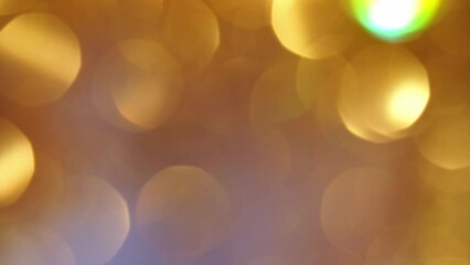 Wall Mural - A natural effect of shimmering gold bokeh movement. Motion Blurred glitter glitter circles . Abstract moving background in 4K resolution.