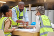 © Tshidzumba/peopleimages.com - Construction planning, meeting and architecture people for blueprint teamwork, collaboration and design questions. Project management, floor plan and manager, woman or engineering or industry group