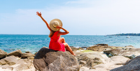 Sticker - Woman with open arms enjoying the sea and fresh air