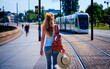 Woman walking in the street and tramway background- Nantes