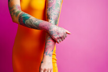 Woman In Yellow Dress With Tattoos On Her Arm And Arm Sleeve. Generative AI.