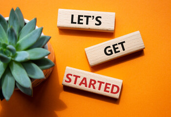 Wall Mural - lets get started symbol. concept words lets get started on wooden blocks. beautiful orange backgroun