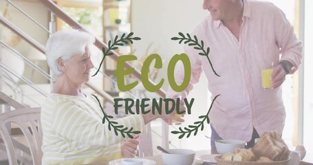 Canvas Print - Animation of eco friendly text over caucasian senior couple eating at home