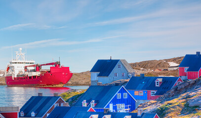 Wall Mural - Arctic Ship leaving Tasiilaq after having unloaded at the docks in the harbour - Tasiilaq, Greenland