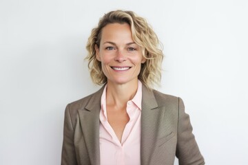 Wall Mural - Portrait of smiling businesswoman with hand in pocket against white background