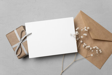 greeting card mockup with gift and envelope, blank card mockup with copy space
