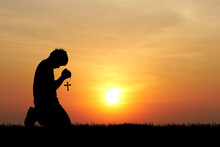 Silhouette Of Lonely And Desperate Man Praying To God