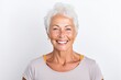 Portrait of a happy senior woman smiling at camera against white background