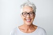 © igolaizola - Close up portrait of smiling senior woman wearing eyeglasses standing isolated over white background
