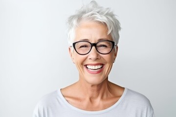 Wall Mural - Close up portrait of smiling senior woman wearing eyeglasses standing isolated over white background
