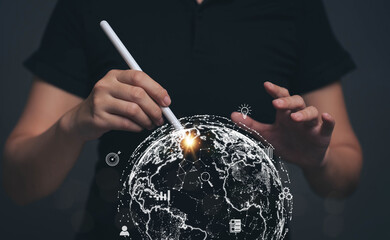 Poster - Hand holding a pen pointing at the globe picture. The concept of searching for information needs through internet technology. Targeting for Online Marketing