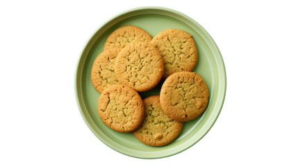 You can see a green plate with some whole and crushed cookies made from wheat on a transparent background. The view is from the top and there is room for additional text.