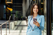 © Maria Vitkovska - Smiling businesswoman wearing formal wear, business suit, holding phone, texting message, copy space