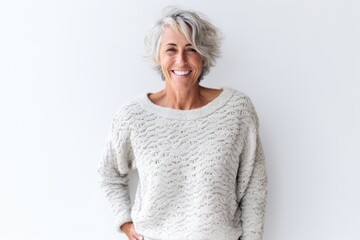 Wall Mural - Portrait of happy senior woman standing with hands on hips against white background