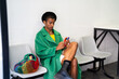 © Alba Vitta/Stocksy - Fancy queer man checking phone in waiting room