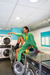 © Alba Vitta/Stocksy - Stylish queer black man at laundry portrait