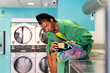© Alba Vitta/Stocksy - Fashionable queer man in laundry