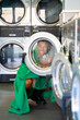 © Alba Vitta/Stocksy - Fancy man through washing machine clear door