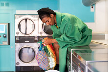 Trendy Gay Man In Self-service Laundry