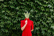 © Tania Cervian/Stocksy - Unknown woman covering face with big leaf
