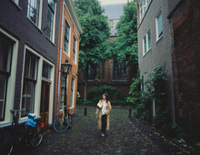Woman Walking In Old Dutch Town 