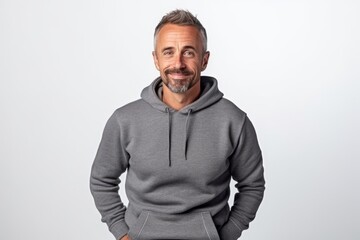 Wall Mural - Portrait of a handsome mature man in grey hoodie standing on white background