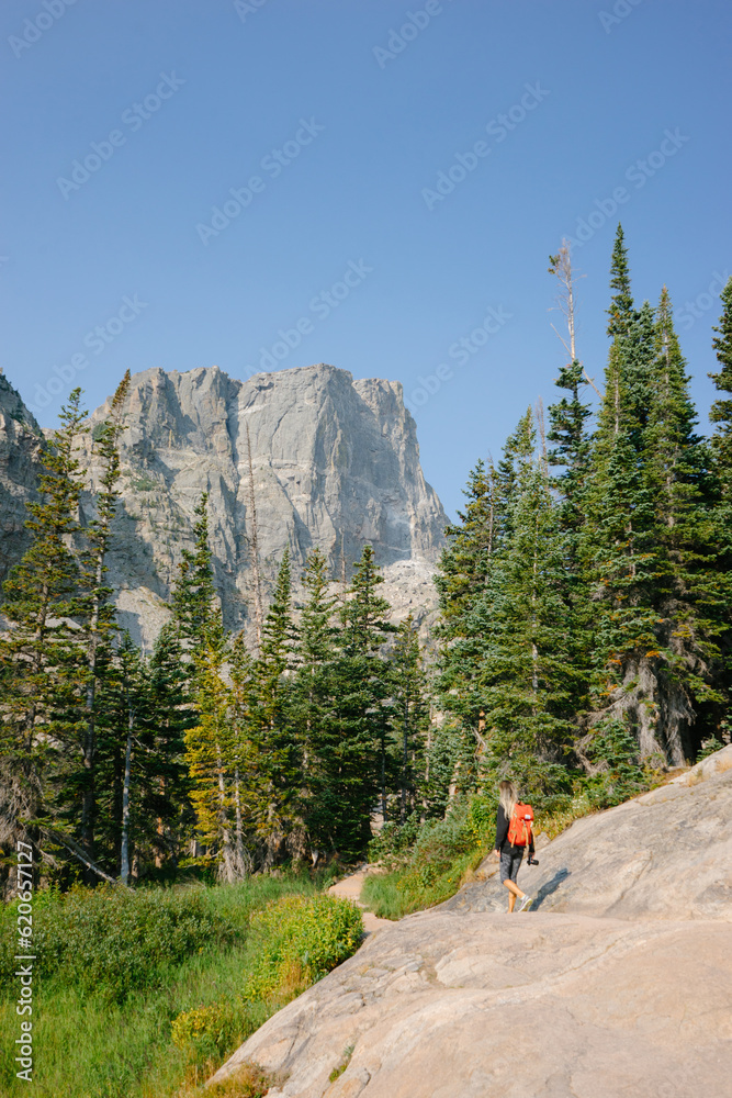 Woman hiking in mountains Stock Photo | Adobe Stock