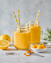 Mango And Orange Smoothie Drinks With Turmeric And Lemon
