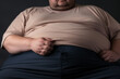 Close up of an obese mans overweight tummy. Unhealthy waistline
