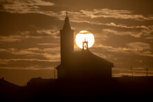Sun Aligned With The Silhouette Of The Church Of Luarca, Asturias, Spain