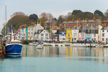 View Of The Colourful Houses And Fishing Boats Around The Marina Of The Popular Seaside Village Of Weymouth, Jurassic Coast, Dorset, England