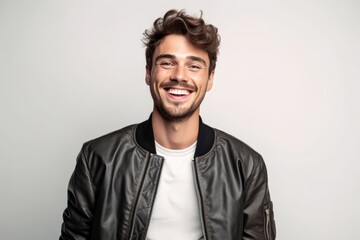 Wall Mural - Portrait of a smiling young man in leather jacket looking at camera