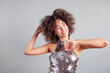 © ALTO IMAGES/Stocksy - Smiling woman in sequin dress