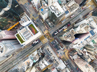 Wall Mural - Cityscape skyscraper buildings, car traffic transport on road in Mong Kok town district, Hong Kong downtown. Drone aerial top view. Asian people lifestyle, Asia city life or public transportation