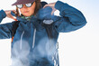 © Christine La/Stocksy - Outdoorsy Women Putting on Hood of Ski Jacket