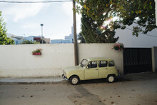 Old Car Parked In Front Of White Wall