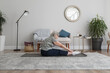 © Danil Nevsky/Stocksy - Senior woman stretching in Seated Forward Bend
