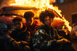 Riot protest in a ghetto suburb such as Paris or Stockholm -  a gang of three young boys with afro hairstyle in front of a burning car in flames