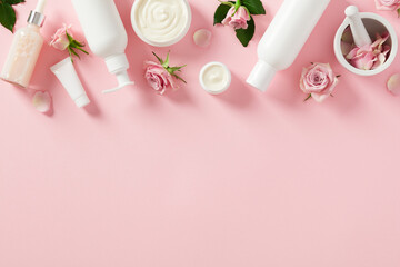 Wall Mural - frame border made of natural cosmetics and skincare beauty products on pink background. flat lay, to