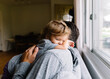 © Maria Manco/Stocksy - Toddler and Father hug on couch