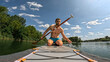 A young man is engaged in water sports, holds an oar in his hands while riding a paddle board sap board