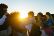 © BONNINSTUDIO/Stocksy - Group of diverse friends spending time together at sunset