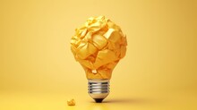 A Crumpled Paper On Top Of A Yellow Light Bulb
