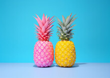 Two Freshly Picked Pineapples Of Pink And Yellow Colors On A Minimal Blue Background. Pop Art Summer Concept. Retro Vintage Poster. Generative AI