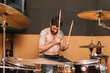 © Ezequiel Giménez/Stocksy - Cool bearded drummer playing drums during rehearsal