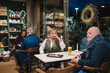 © Daniel Gonzalez/Stocksy - People enjoying dinner in restaurant