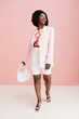 © Sergey Filimonov/Stocksy - Happy woman fashion portrait in pink color